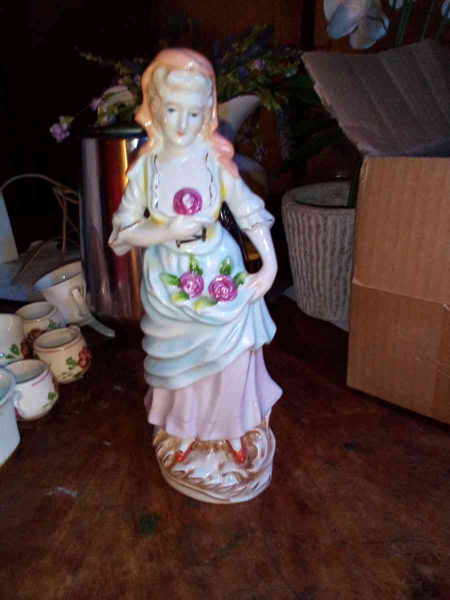 collectible vintage lady holding flower stand