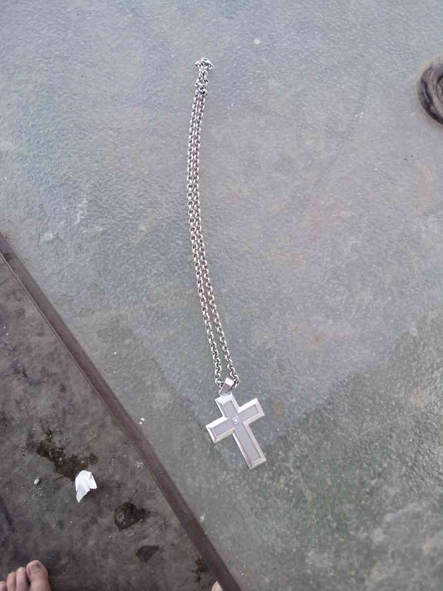 sterling silver necklace with a cross and a diamond in the m