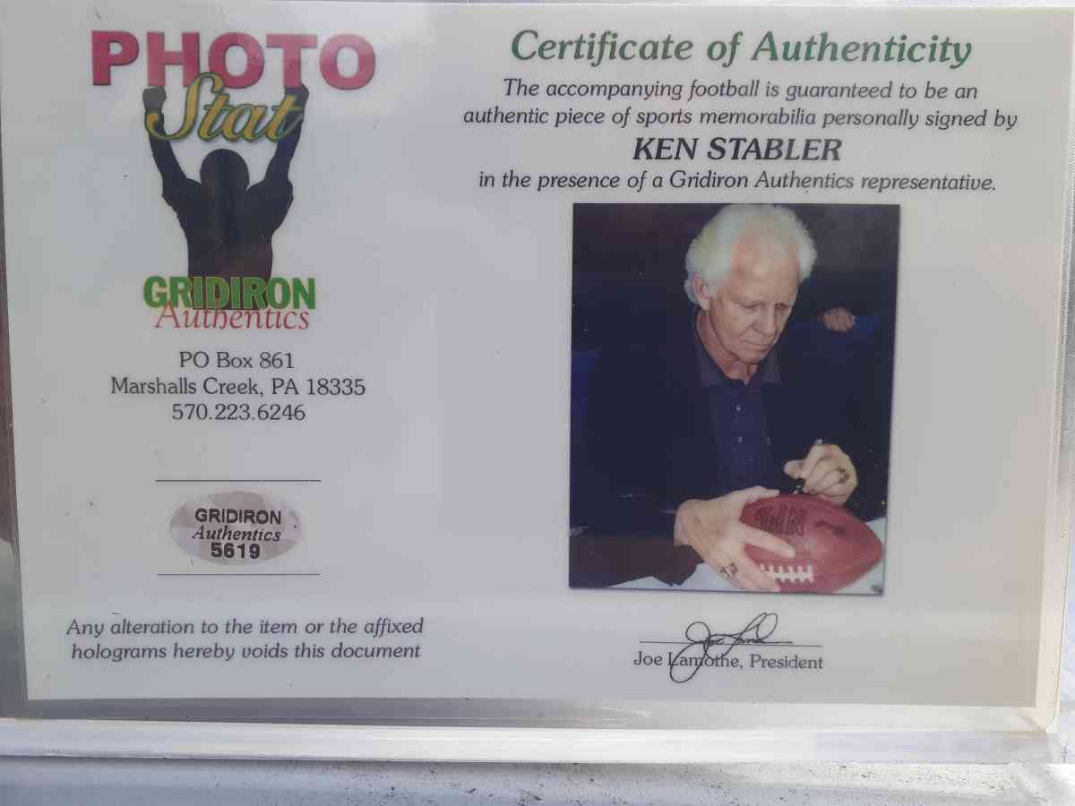 an autographed Ken Stabler football in an acrylic case