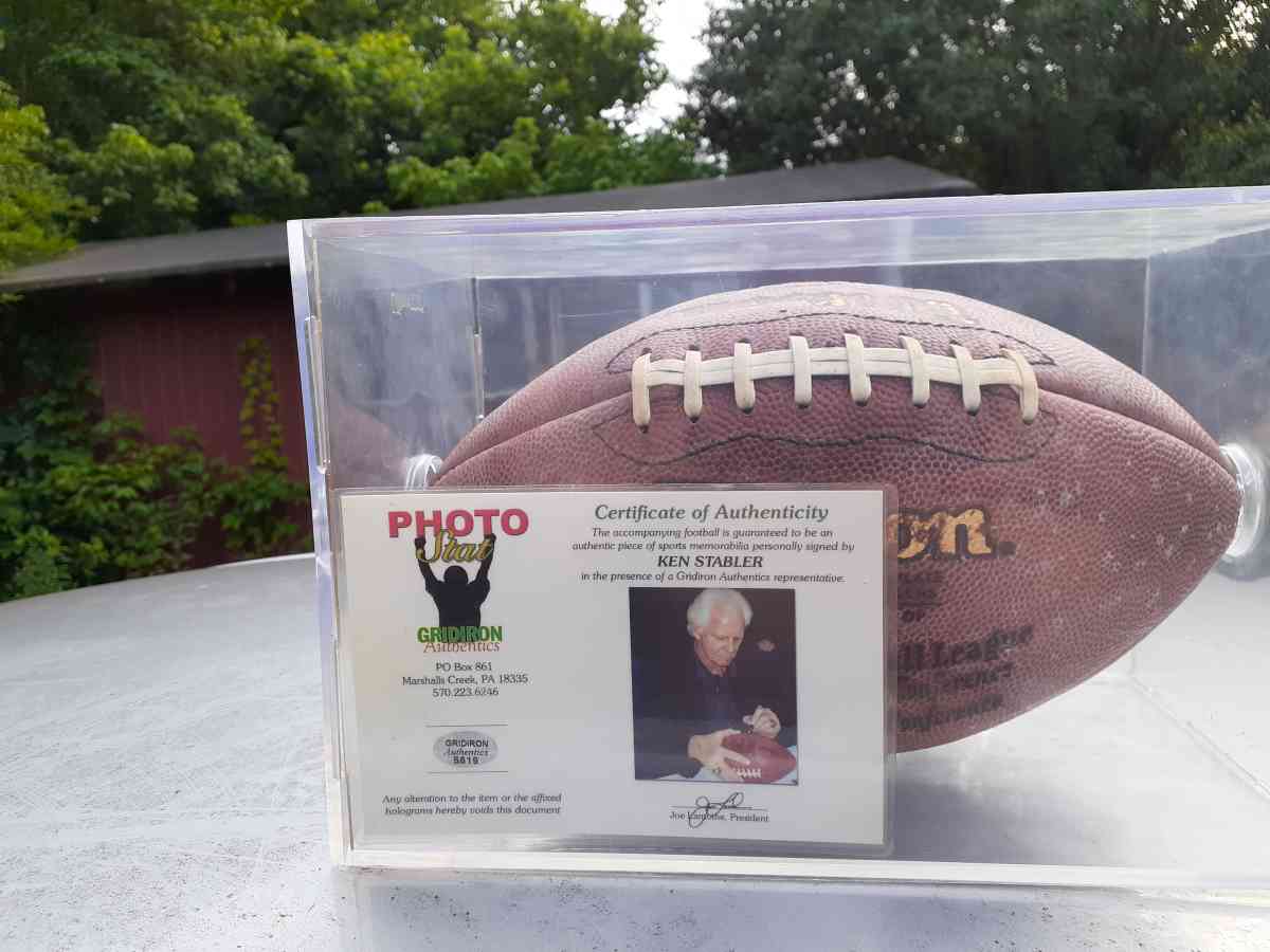 an autographed Ken Stabler football in an acrylic case