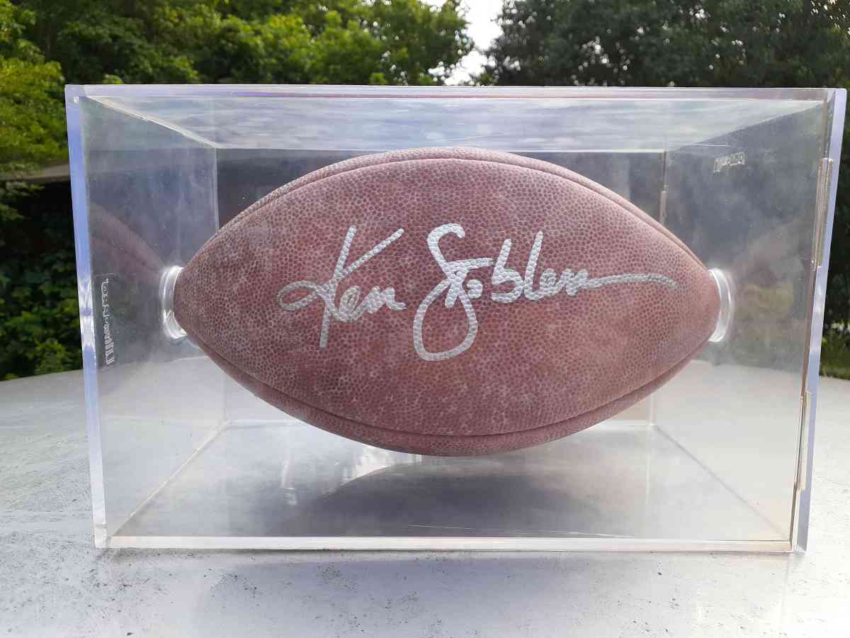 an autographed Ken Stabler football in an acrylic case