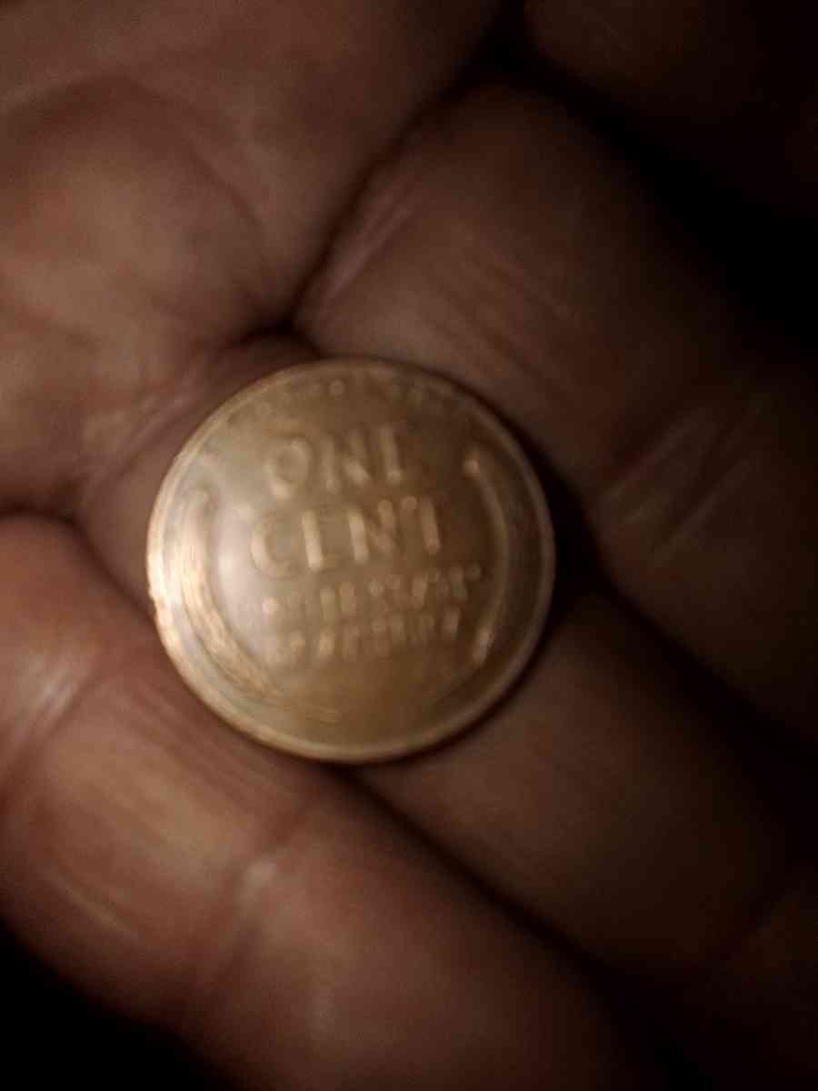 1957 d wheat penny with obverse error on the b on liberty