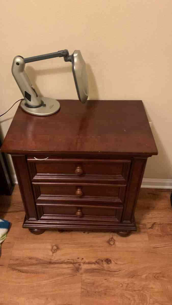 a couch a bed a dresser and a tv stand and a side table