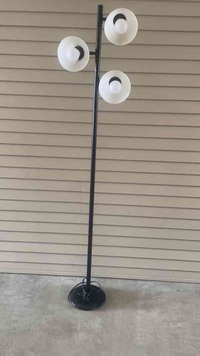 tall black lamp with three head lights