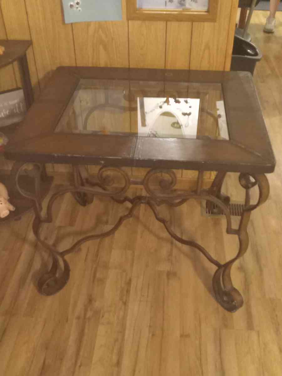 wooden metal table with glass in the middle of it