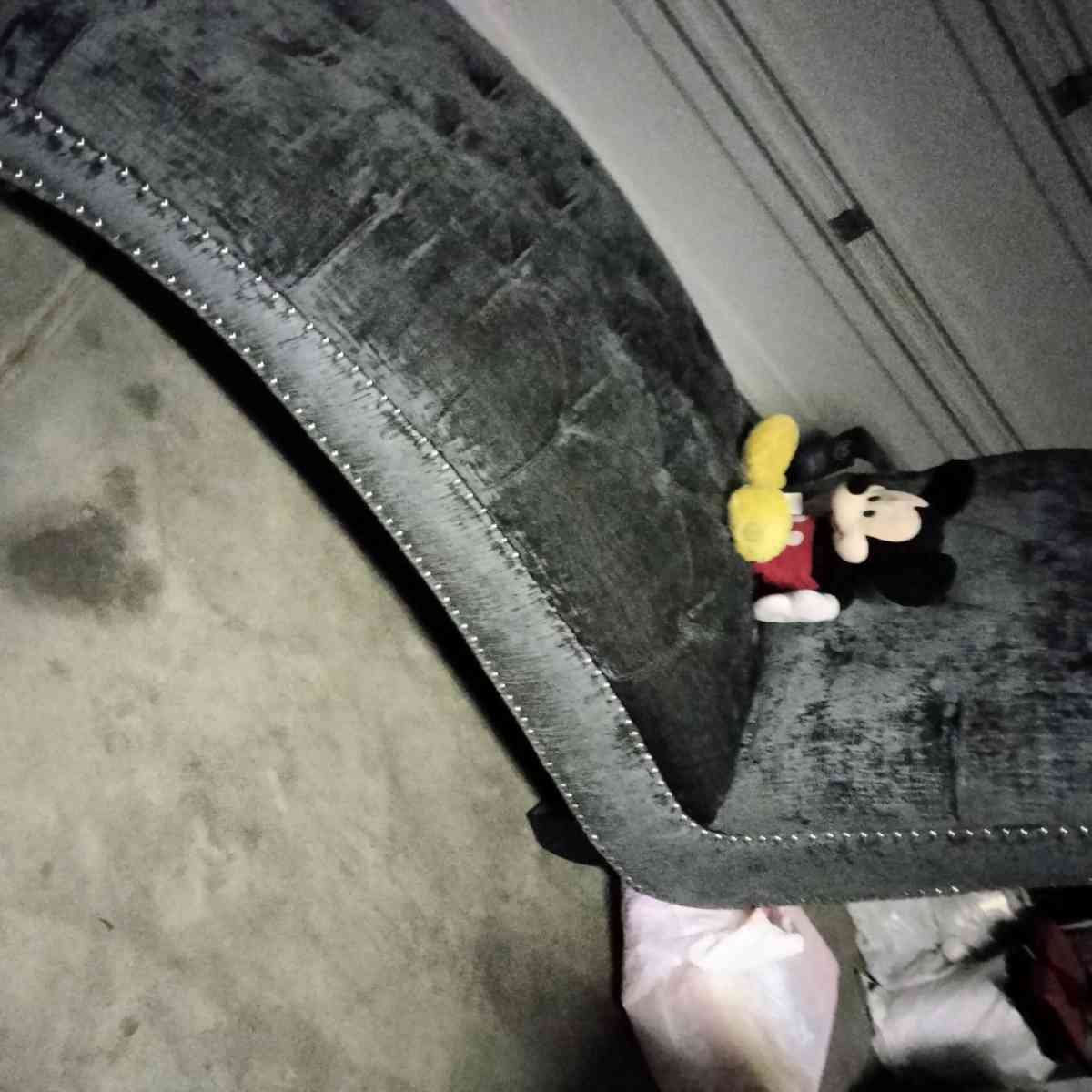 blue buttoned curvy tuffed sofa