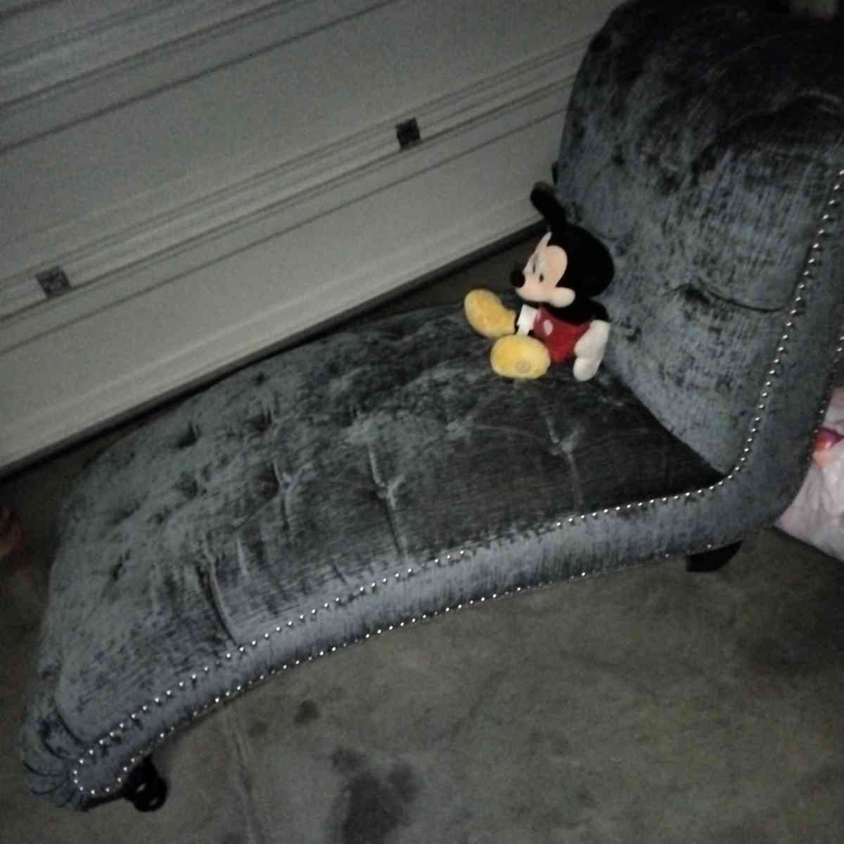 blue buttoned curvy tuffed sofa