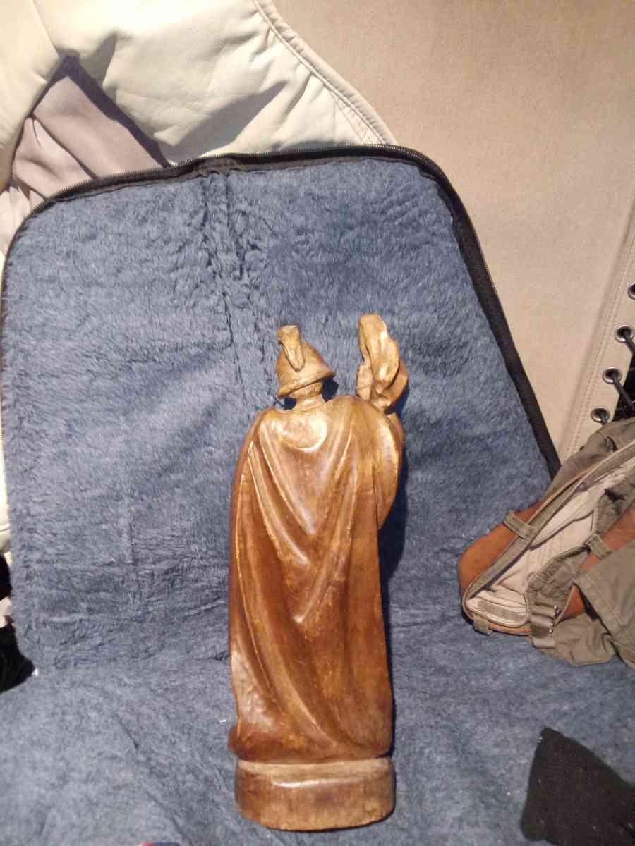 wood carving of a Roman firefighter