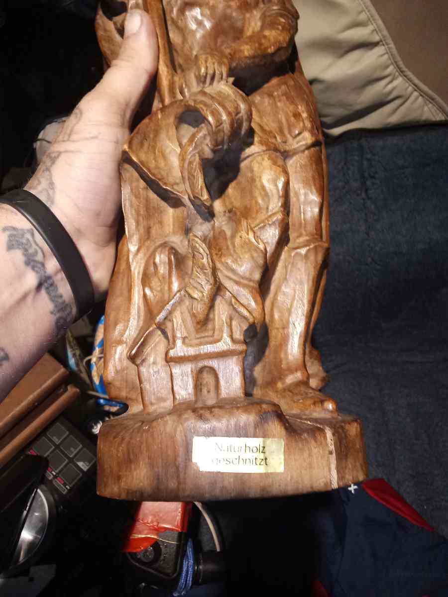 wood carving of a Roman firefighter