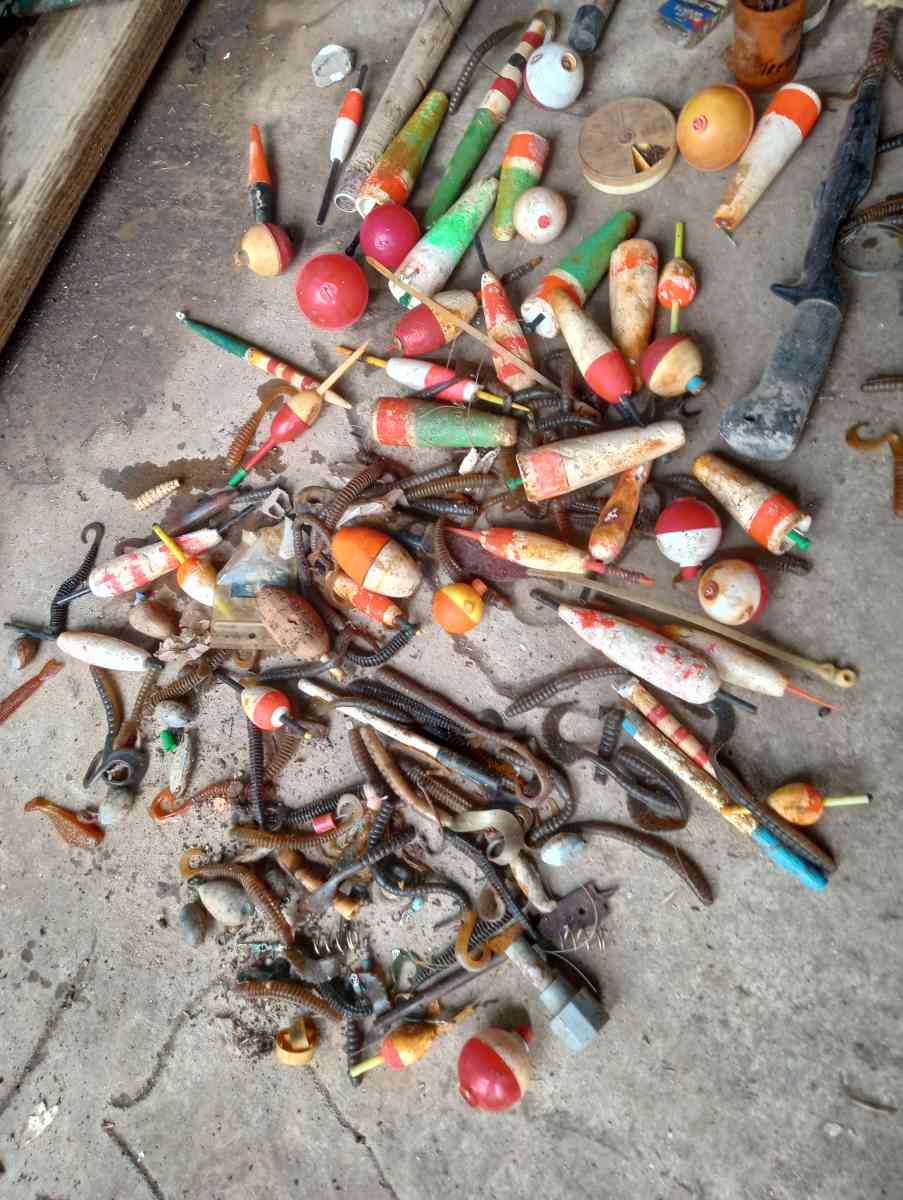 old boat parts and fishing poles and tackle