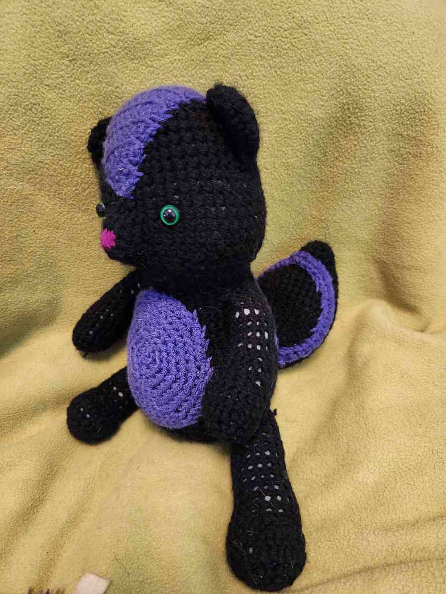 Spunky the black and purple Skunk