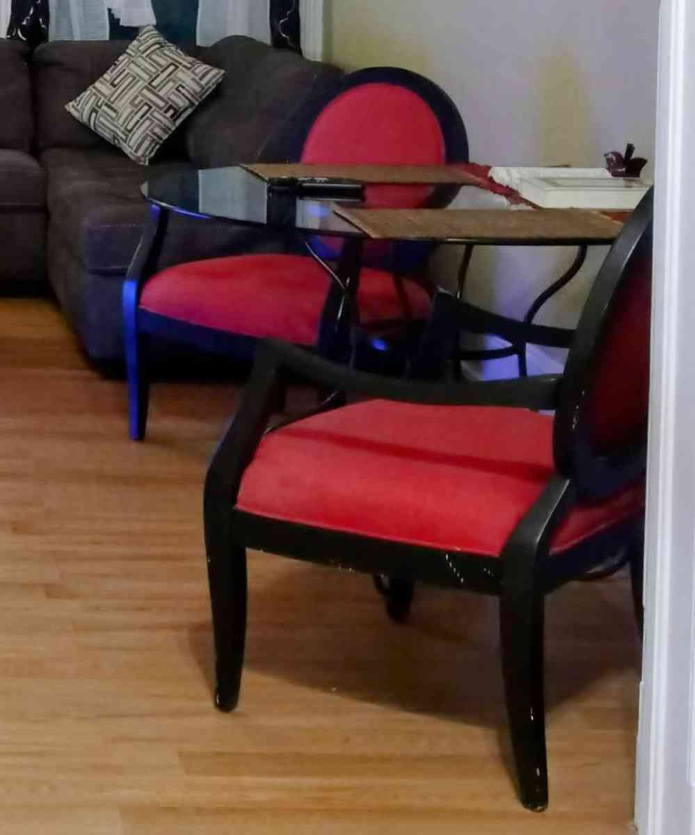 glass table with 2 red black vintage chairs