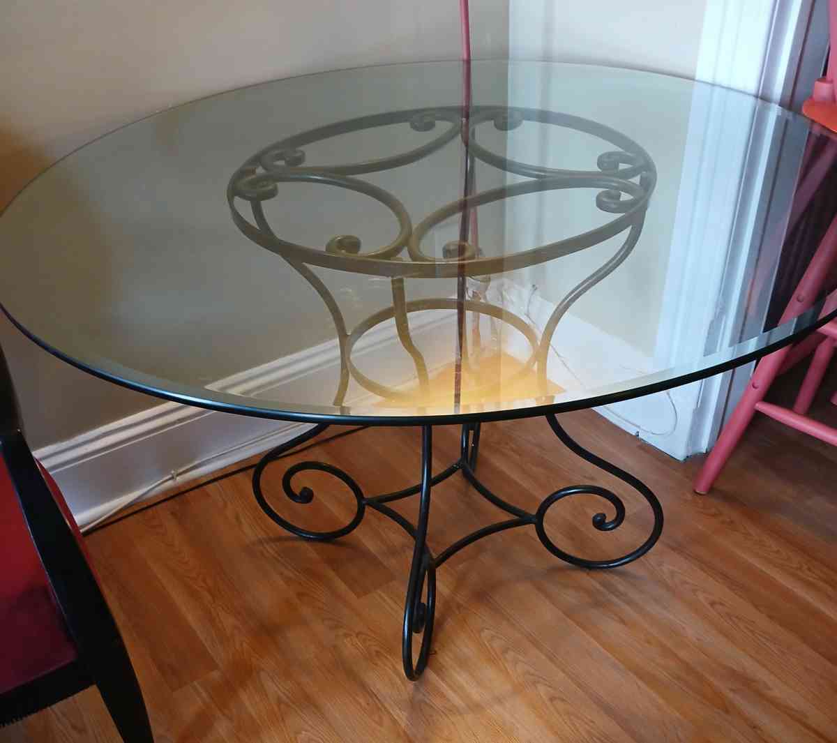 glass table with 2 red black vintage chairs