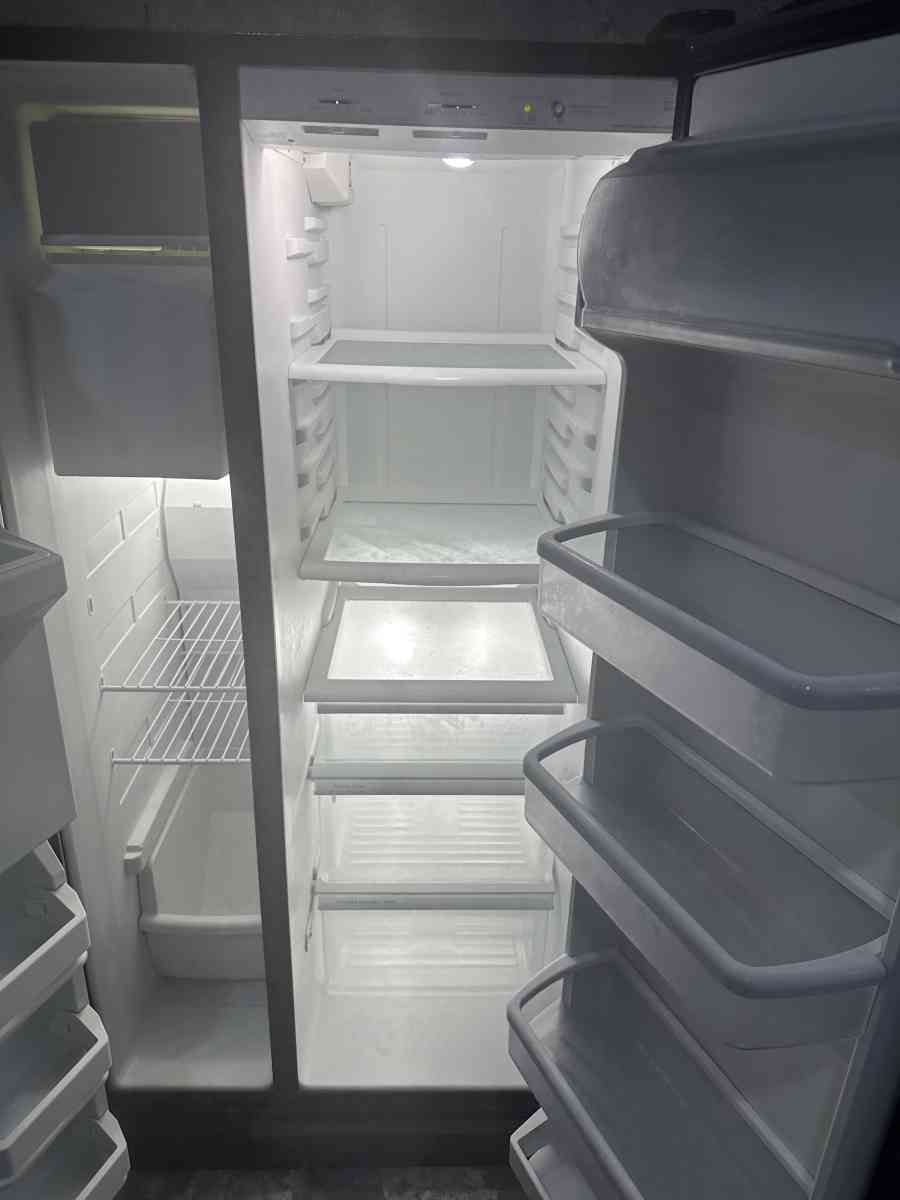 GE refrigerator side by side with water and ice maker dispen