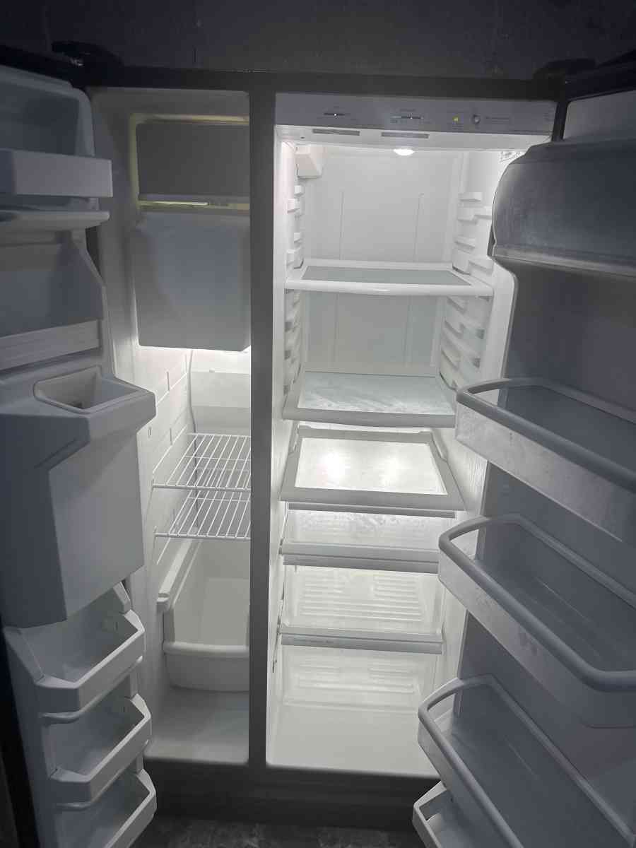 GE refrigerator side by side with water and ice maker dispen