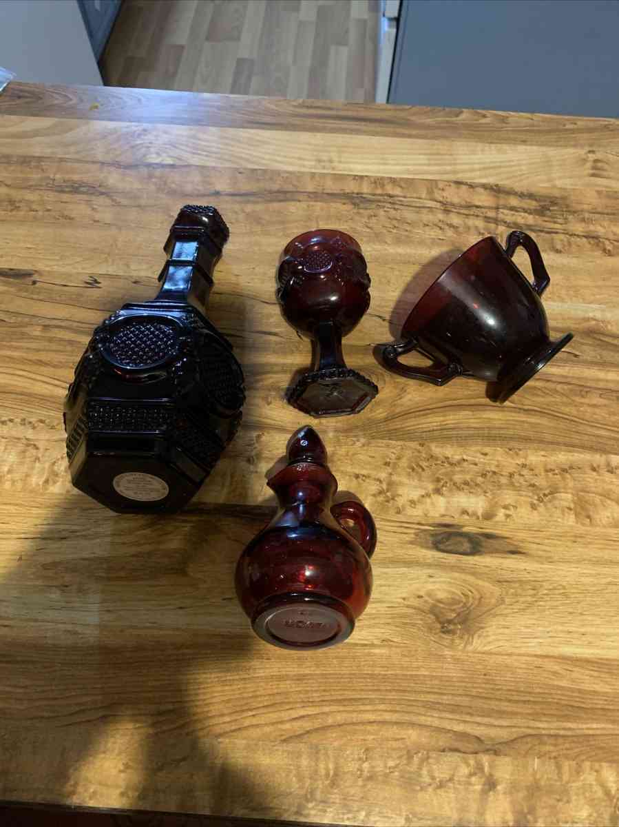 vintage Avon bubble bath decanter with a candle and cup