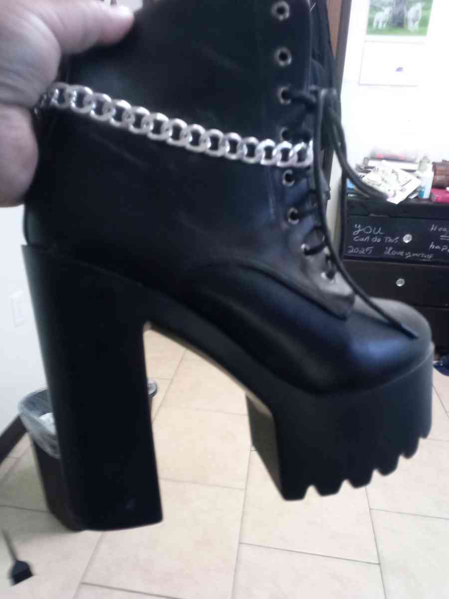 a pair of black platform boots high heeled