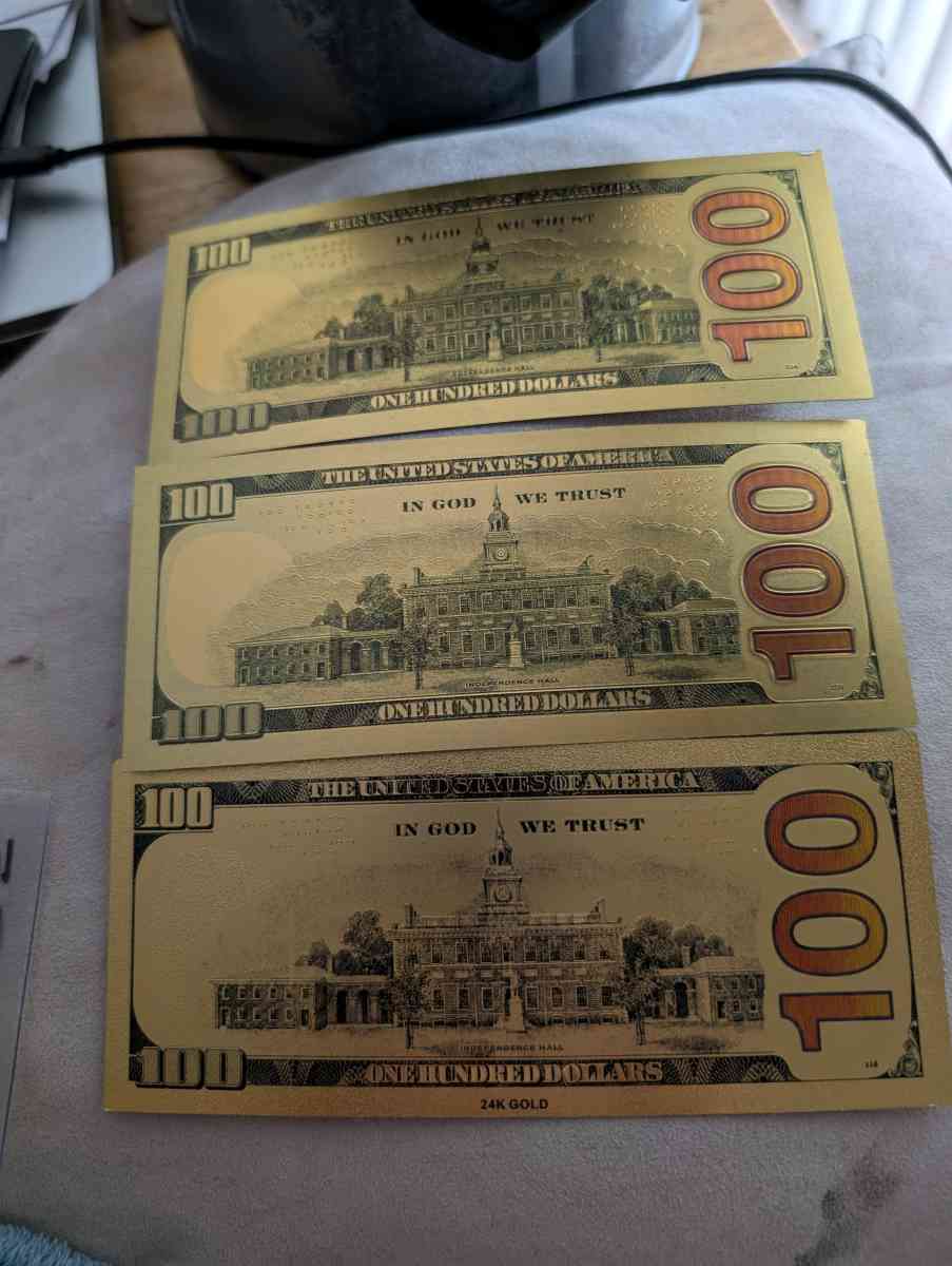 Three gold 100 bills