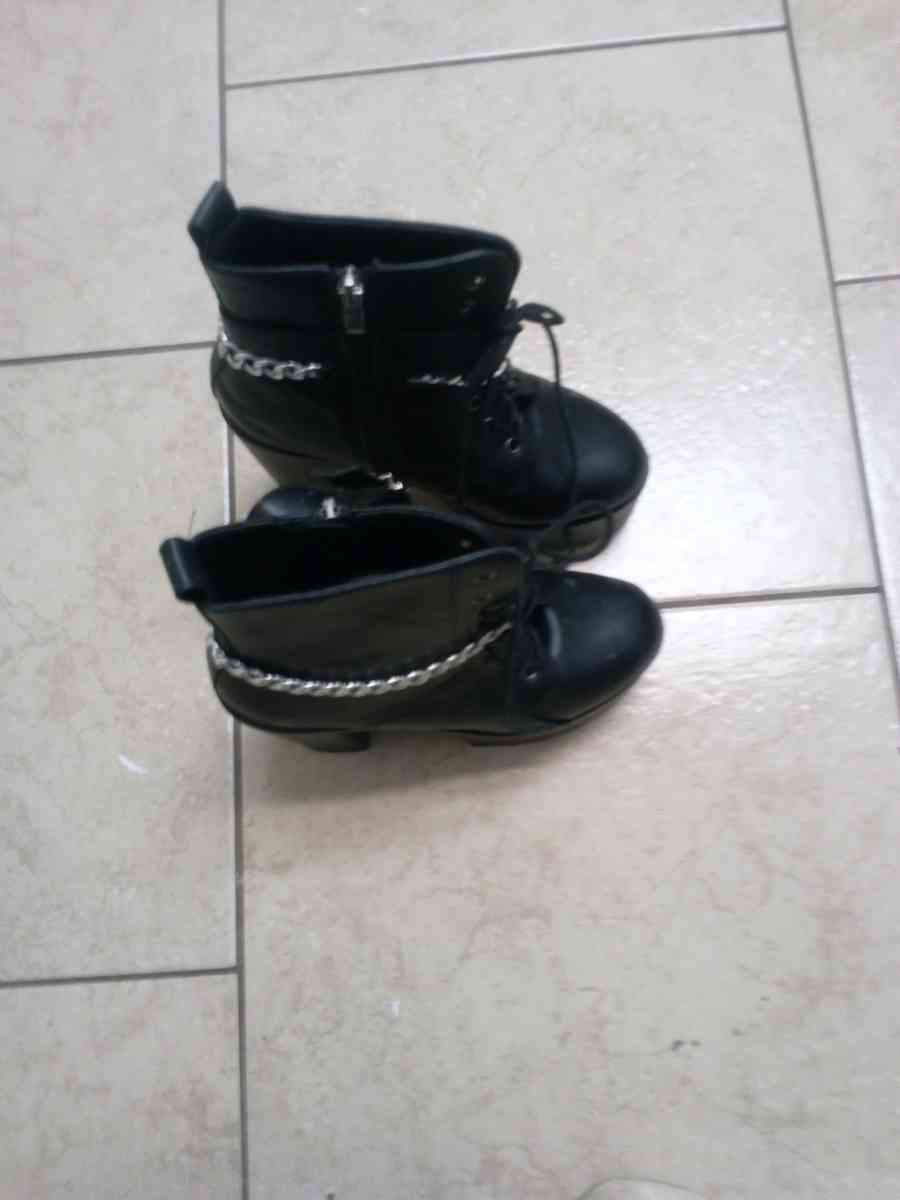 a pair of black platform boots high heeled