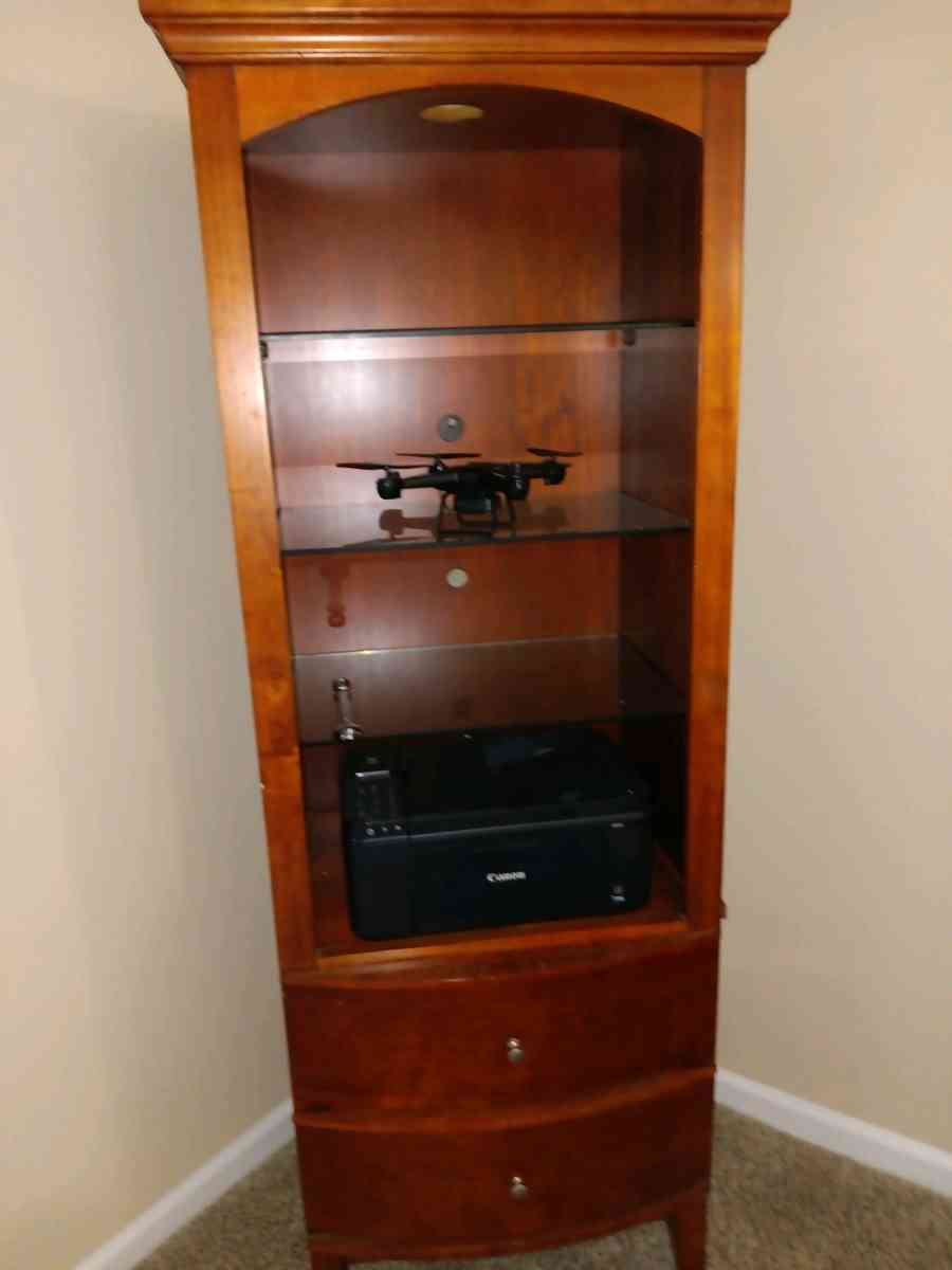 couch and loveseat and cabinet with glass shelves very clean