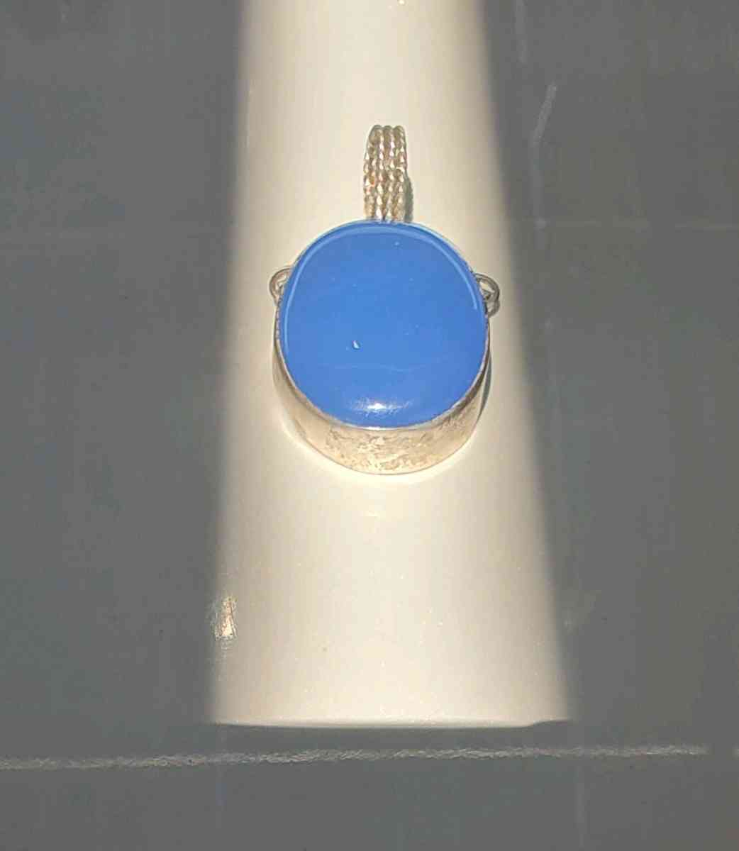 large blue opal cabochon set in sterling silver pendant