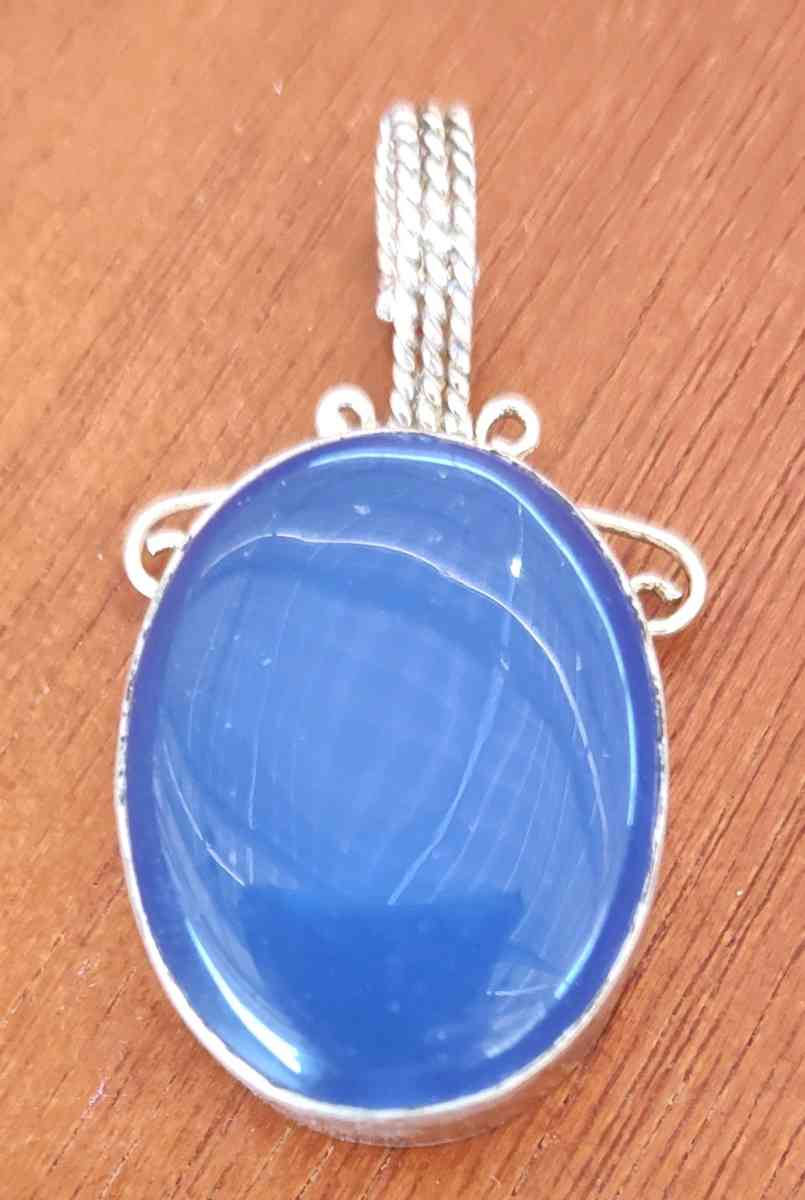 large blue opal cabochon set in sterling silver pendant