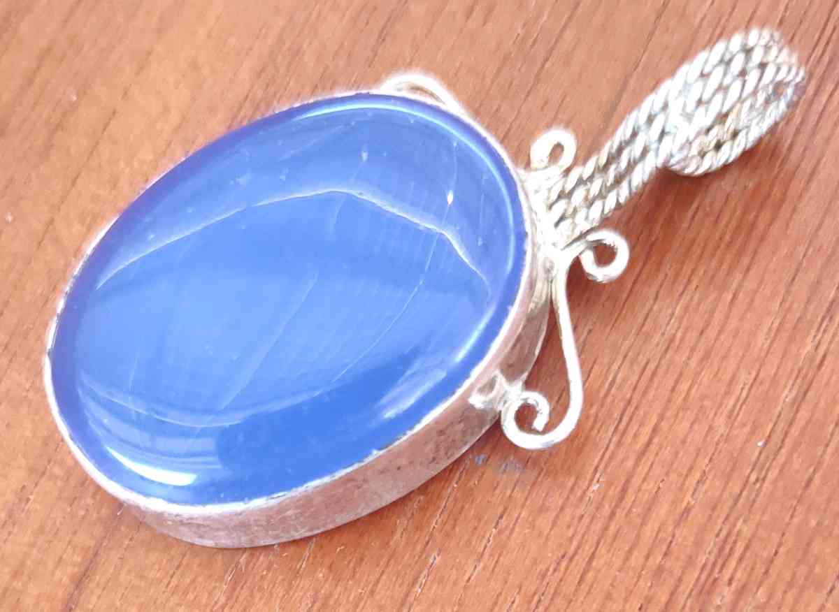 large blue opal cabochon set in sterling silver pendant