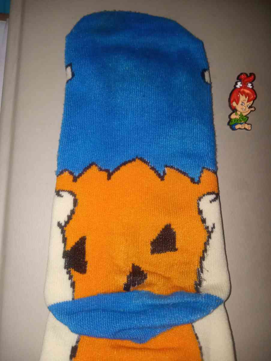 Fred Flintstone socks collectible with a pebbles pin
