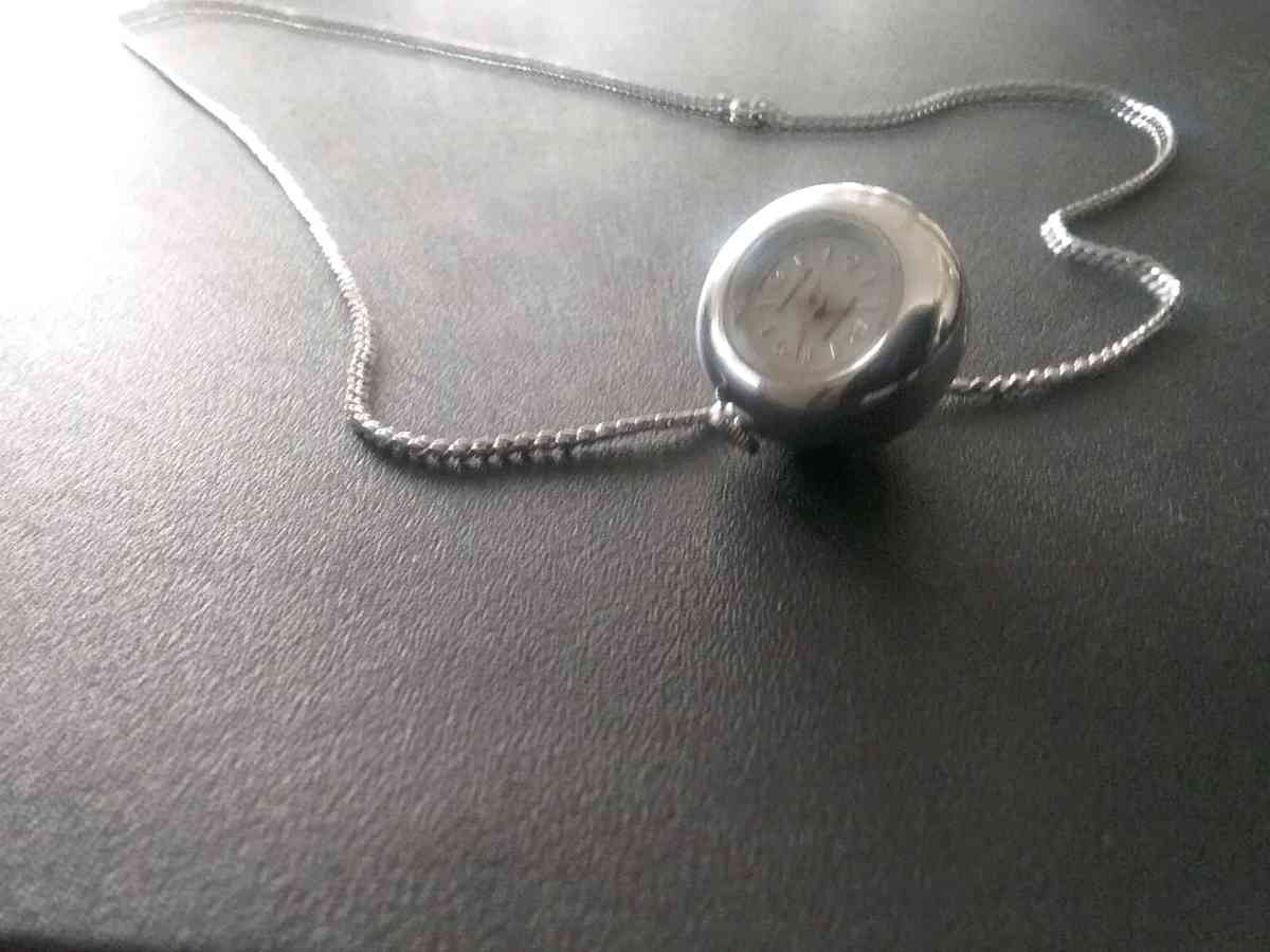 silver necklace with timepiece