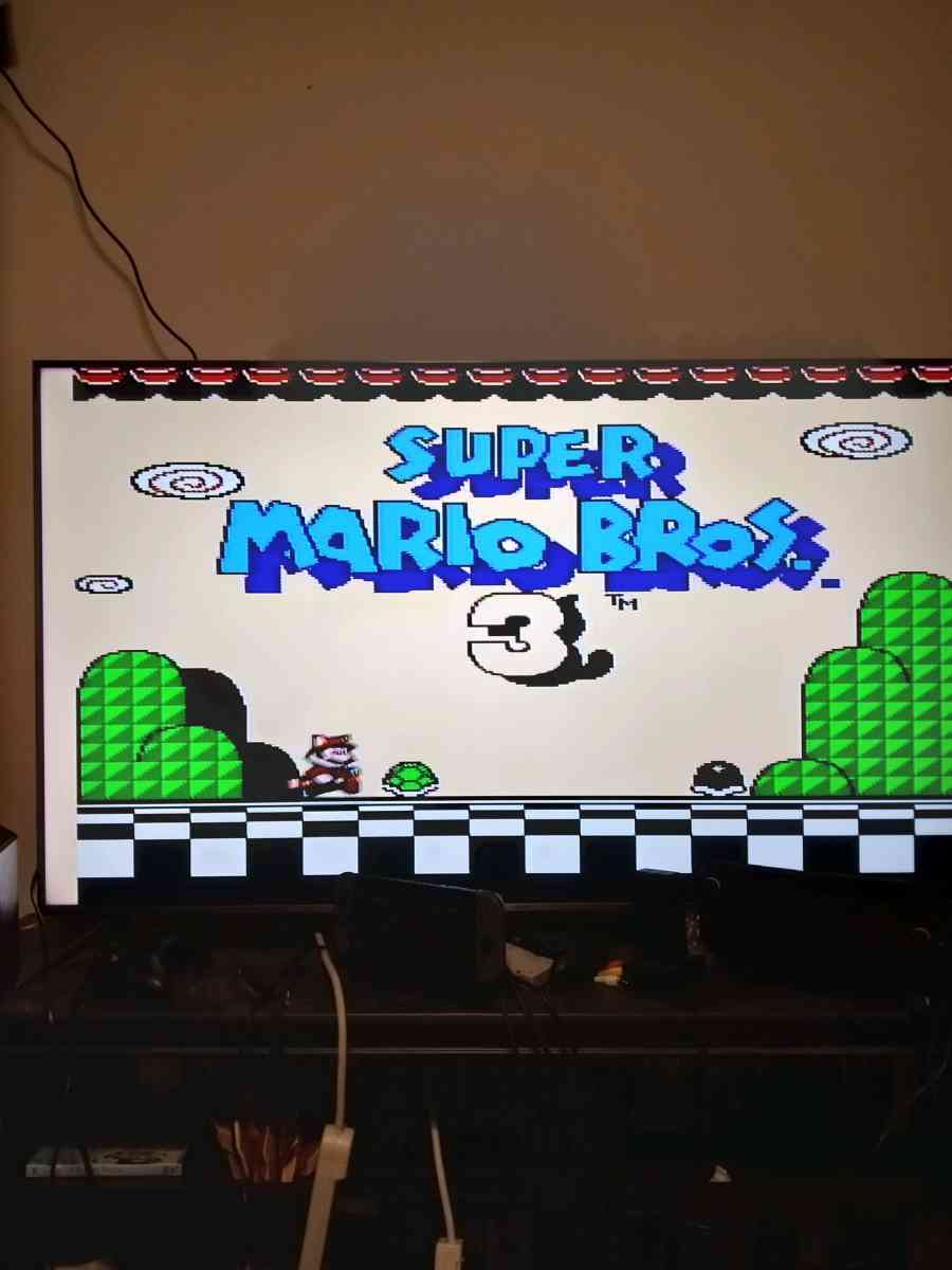 2 Nintendo NES consoles with 3 controllers and 5 games