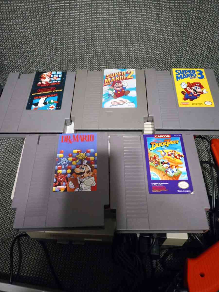 2 Nintendo NES consoles with 3 controllers and 5 games