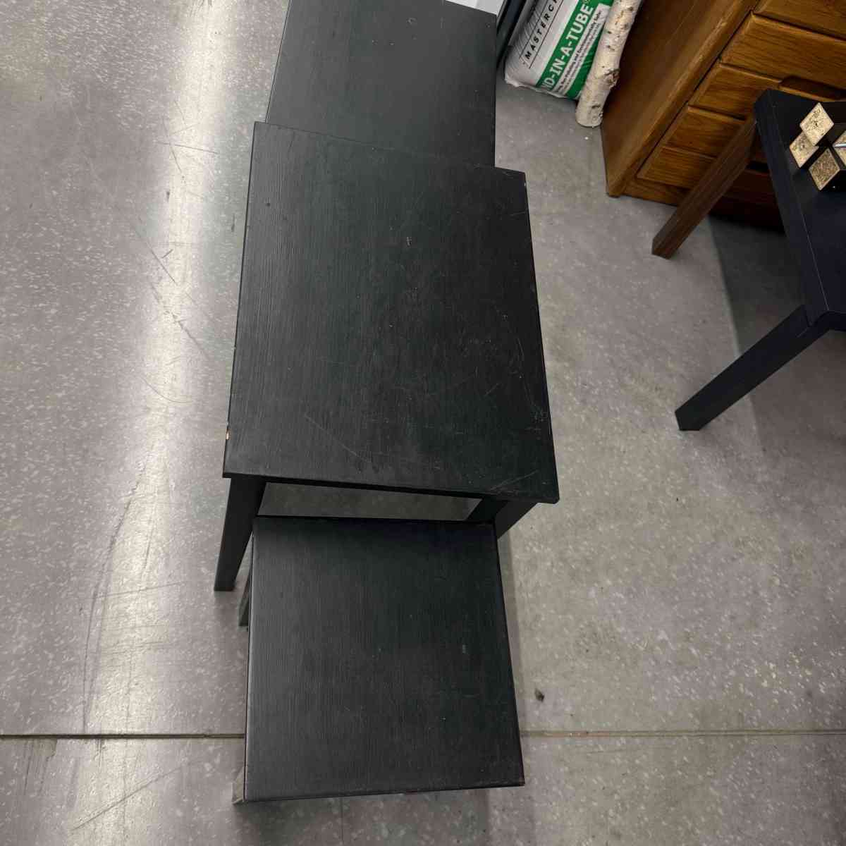 3 black tables slide under the other for easy storing used