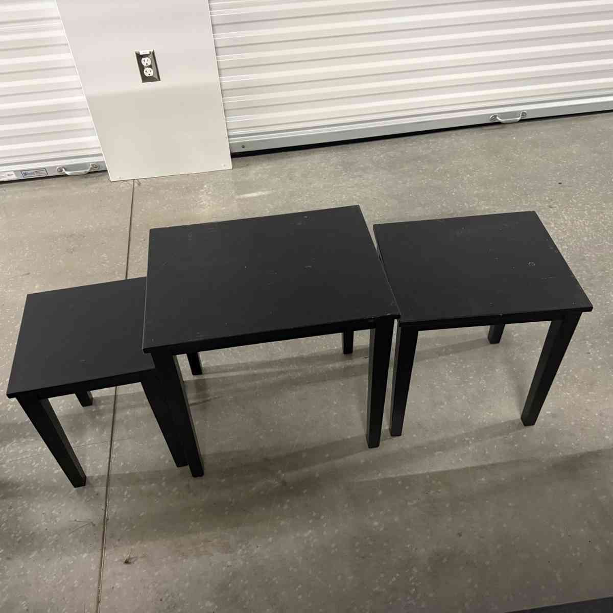3 black tables slide under the other for easy storing used