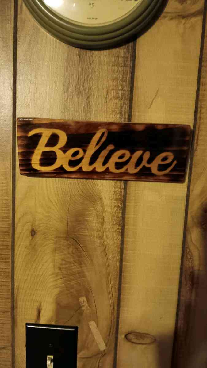 torched Believe sign