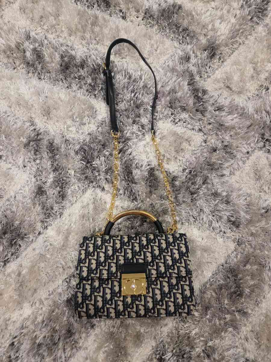 Luxury Monogram Handbag with Gold Accents and Pearl Lock Det