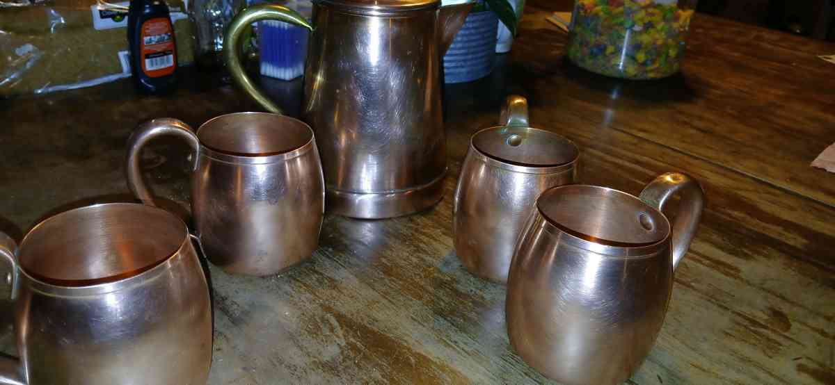 solid copper cups and a coffee pot