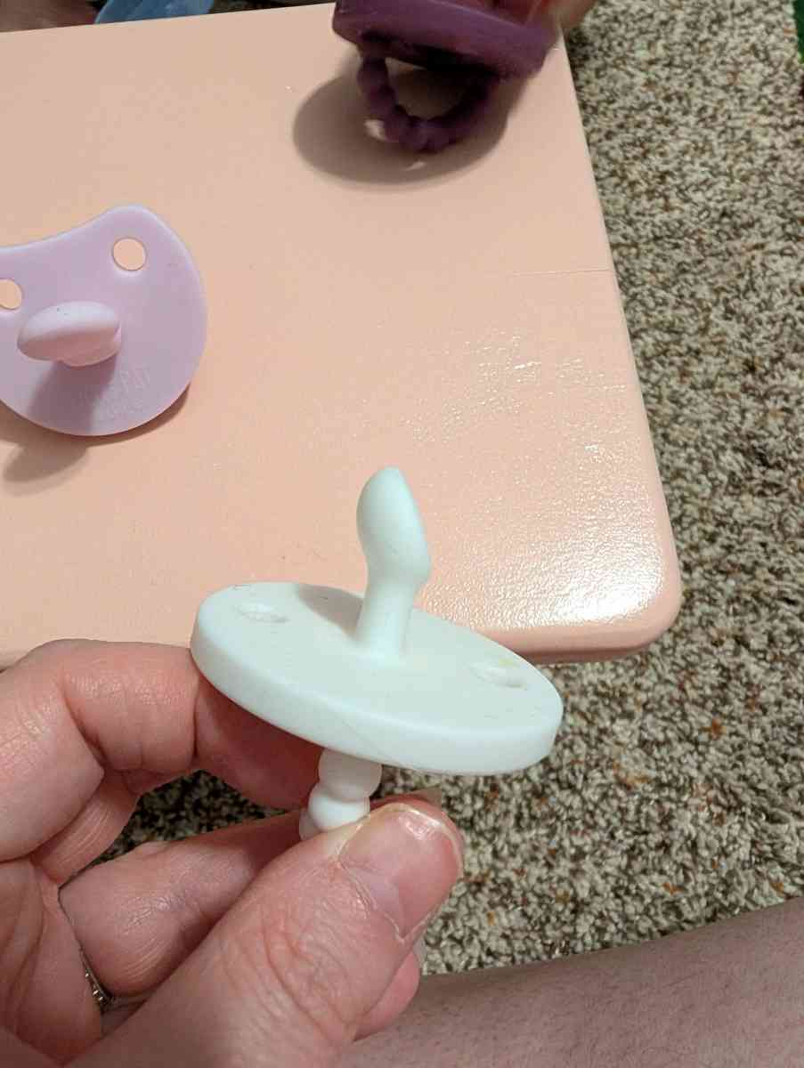 5 Cutie Pat Pacifiers and a teether