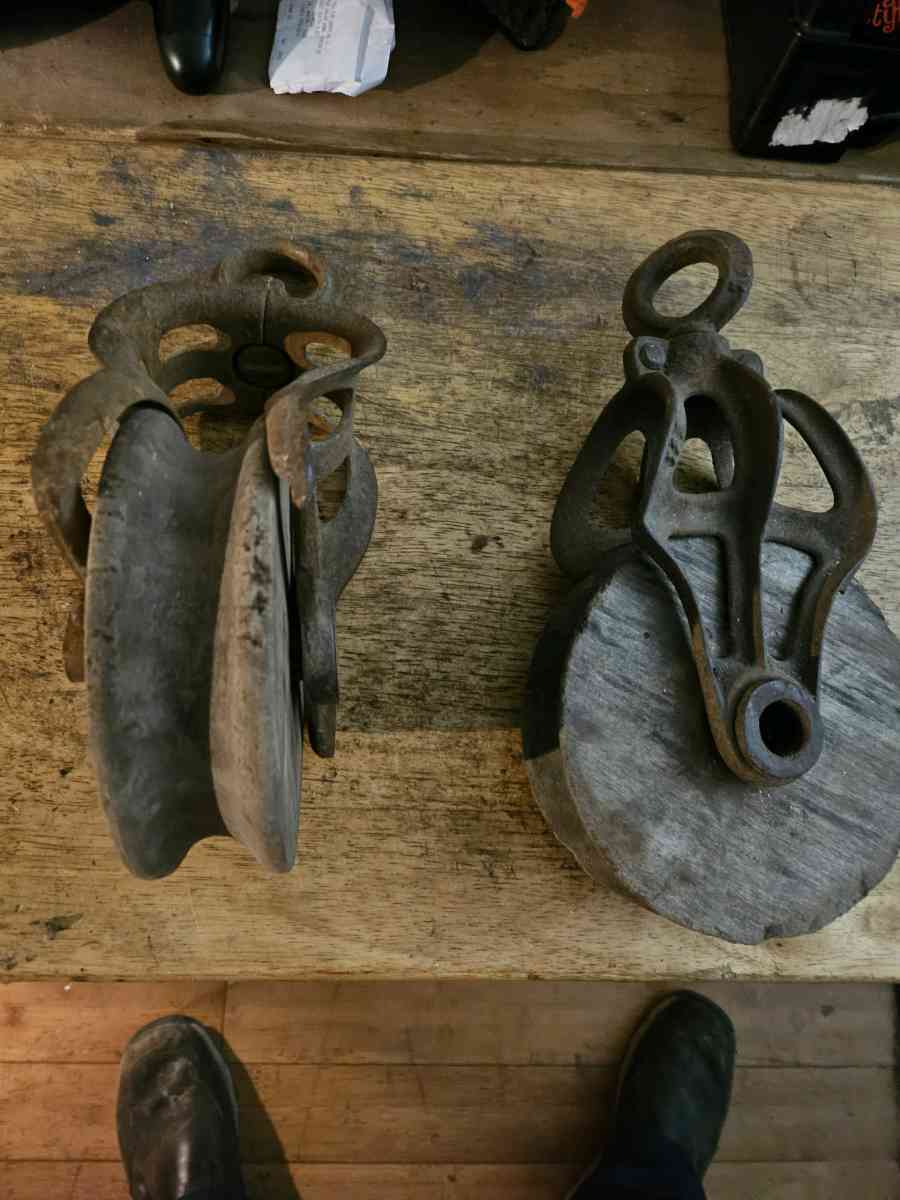 2 old wooden pulleys with metal frames 10 dollars for both