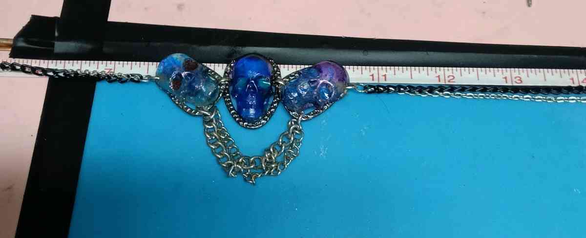 three skulls with multiple chains made with Uv resin